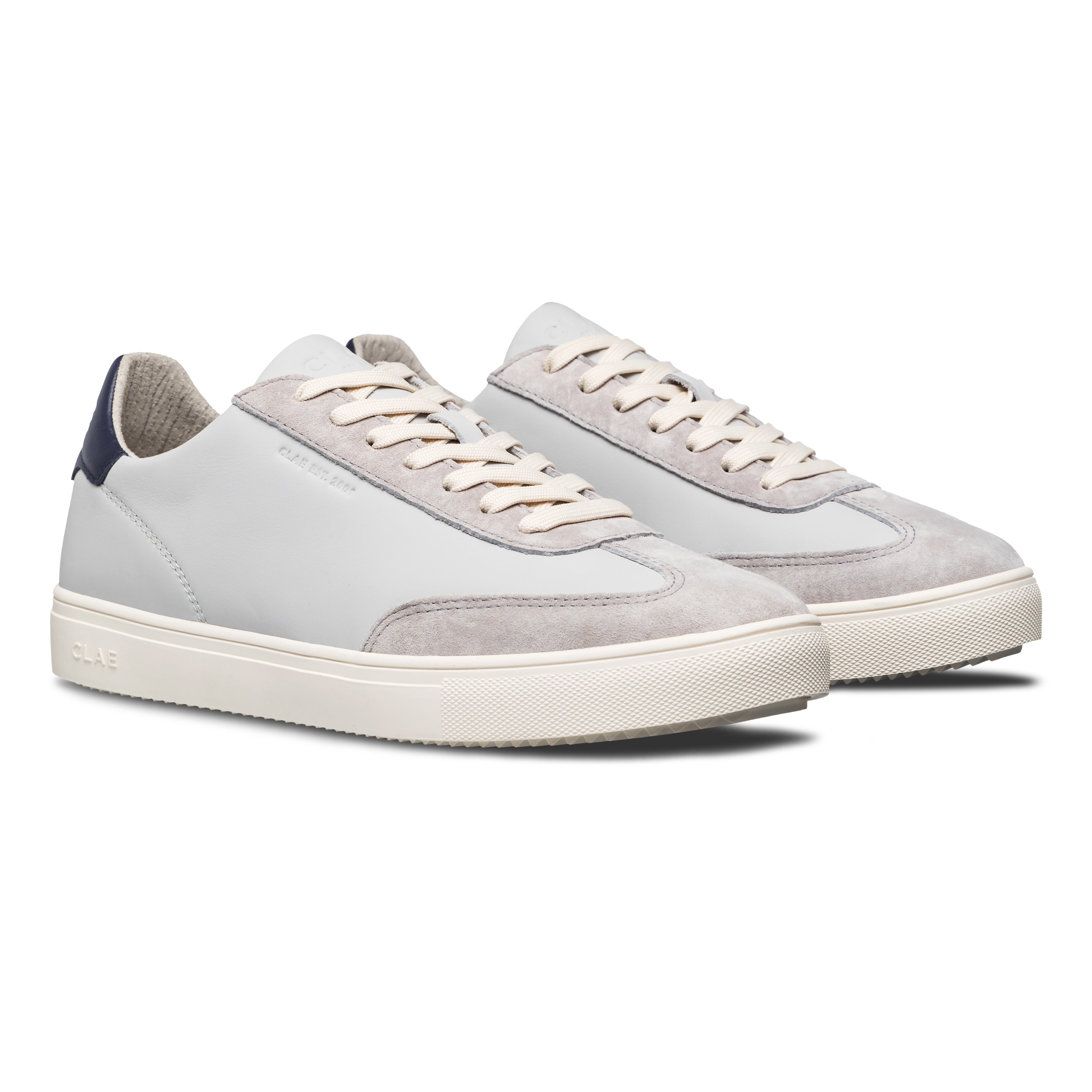 Three-quarter view of Deane court shoe in Quiet Gray Navy, highlighting sophisticated blend of materials and modern heritage design.