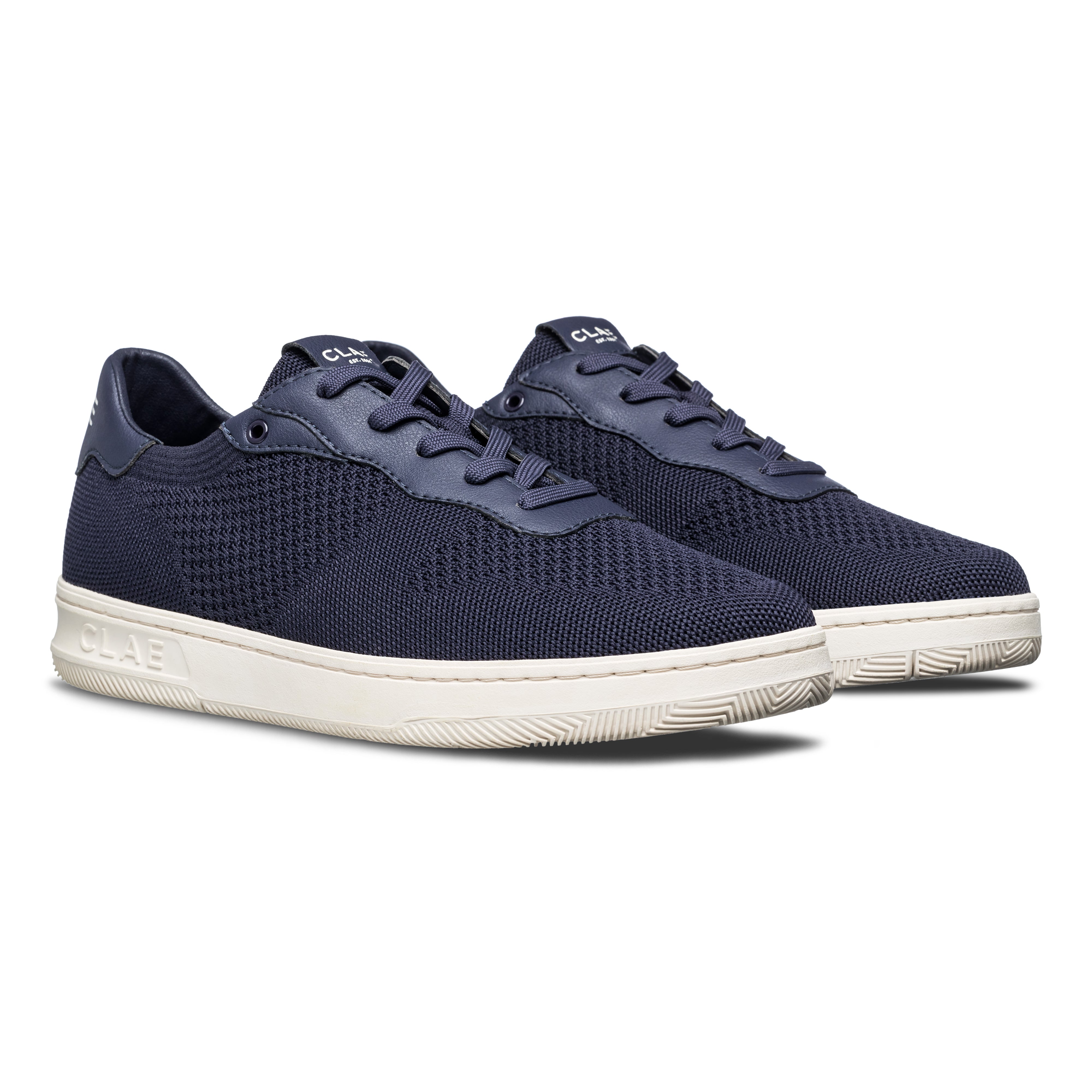 Three-quarter view of Malone Knit shoe in Navy, highlighting lightweight recycled fiber construction and sleek court shoe design.